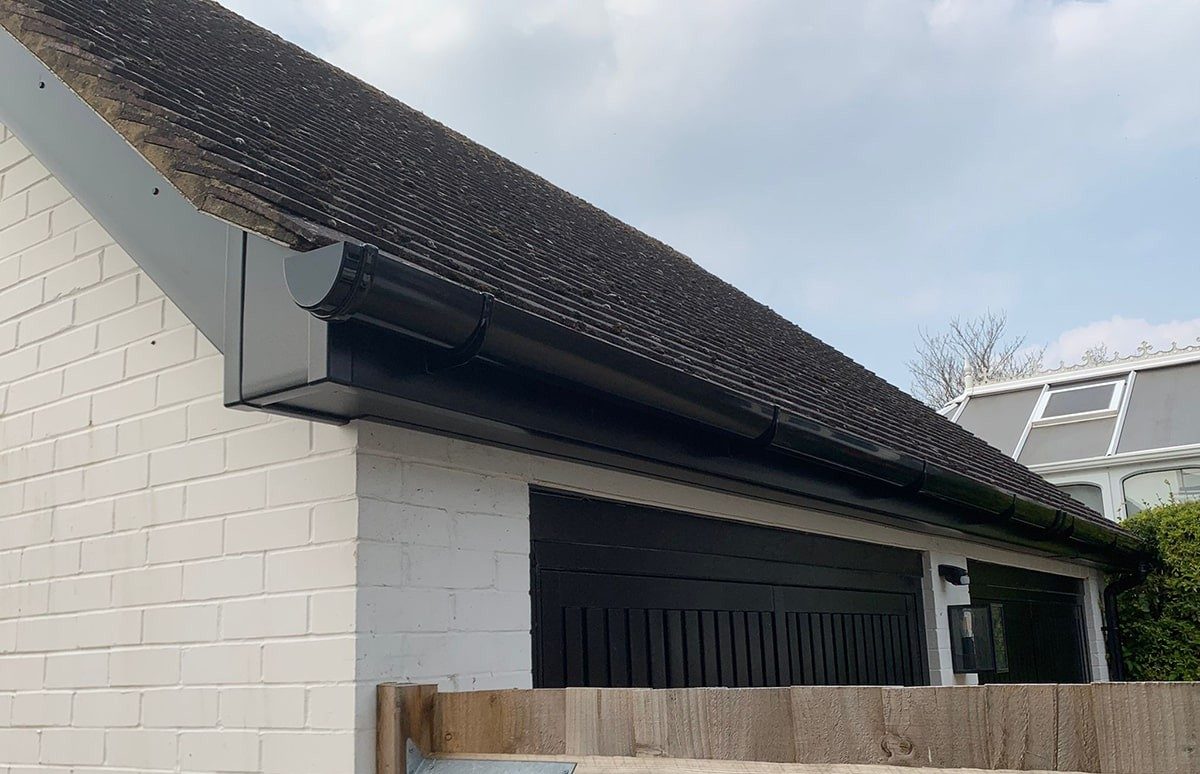 New black guttering fitted to a UK garage