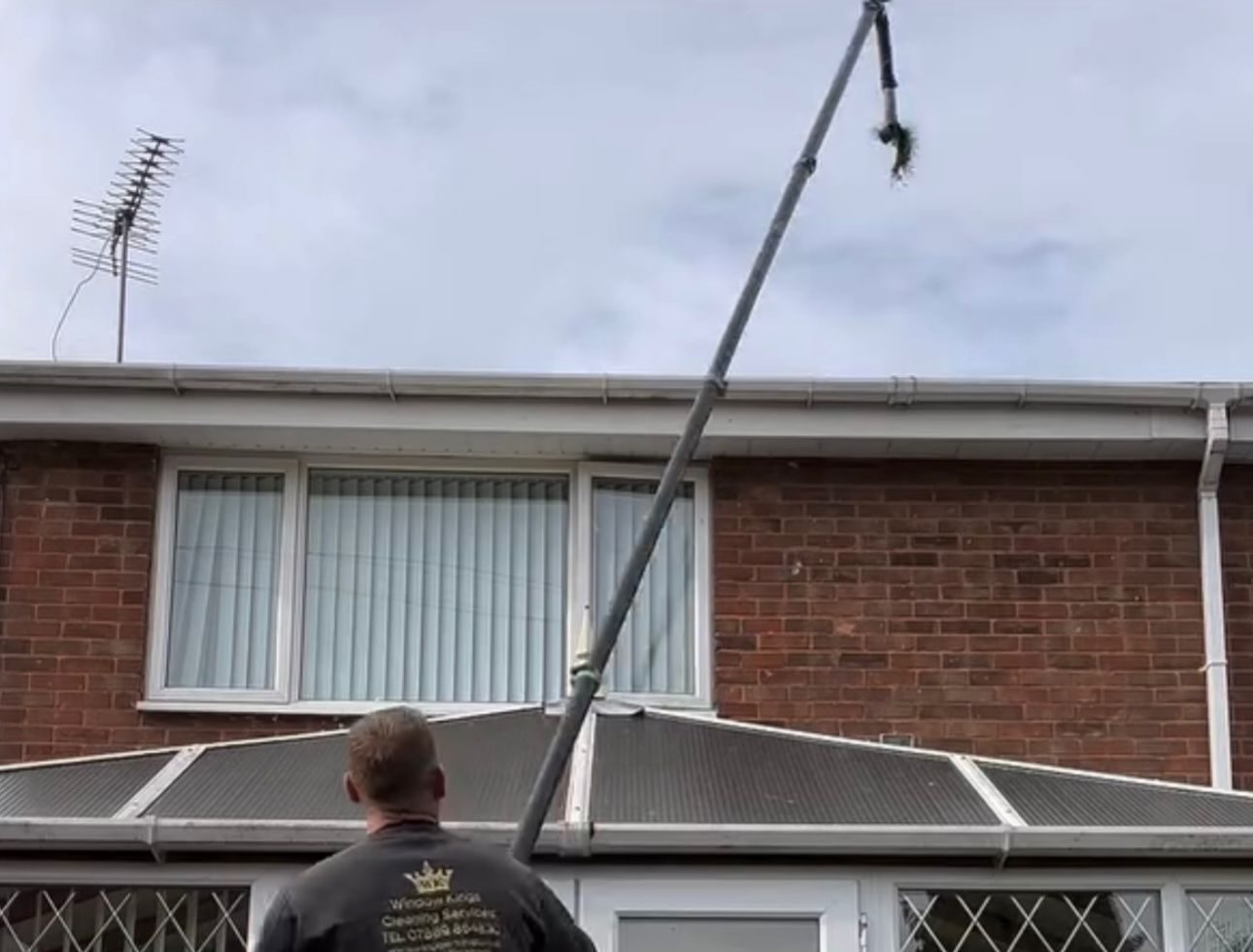 Gutter cleaning being carried out on a British home