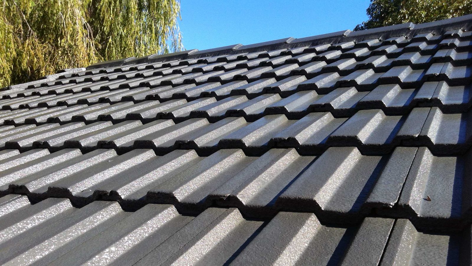 Close up of concrete roof tiles and ridge line on a UK house