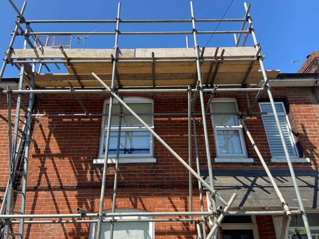 Scaffolding erected on a UK house for roof repair work