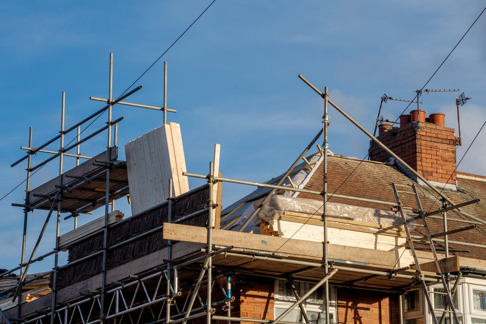 Scaffolded UK house during a full roof replacement